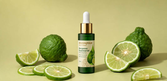 Bergamot essential oil bottle surrounded by fresh bergamot fruit and citrus slices on a green background