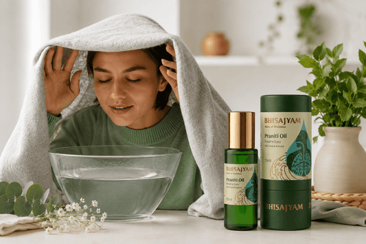 Woman inhaling steam from a bowl with Bhisajyam Praniti Oil placed beside it, demonstrating a natural steam inhalation remedy for nasal congestion, cold, cough, and sinus relief.