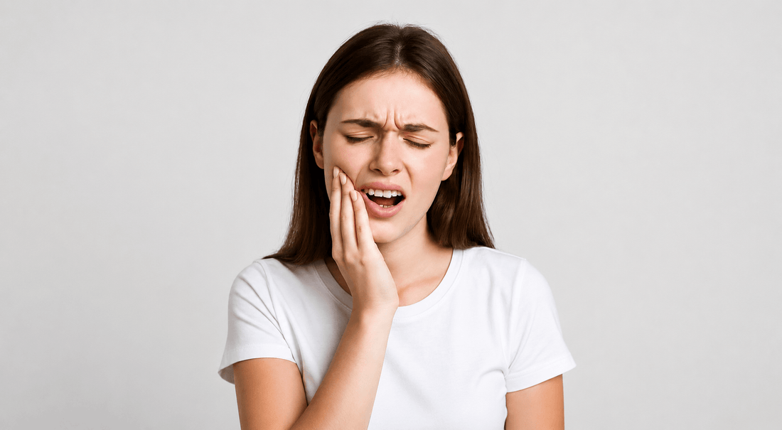 Woman touching her cheek in pain due to toothache and dental discomfort