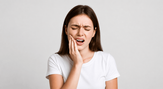 Woman touching her cheek in pain due to toothache and dental discomfort