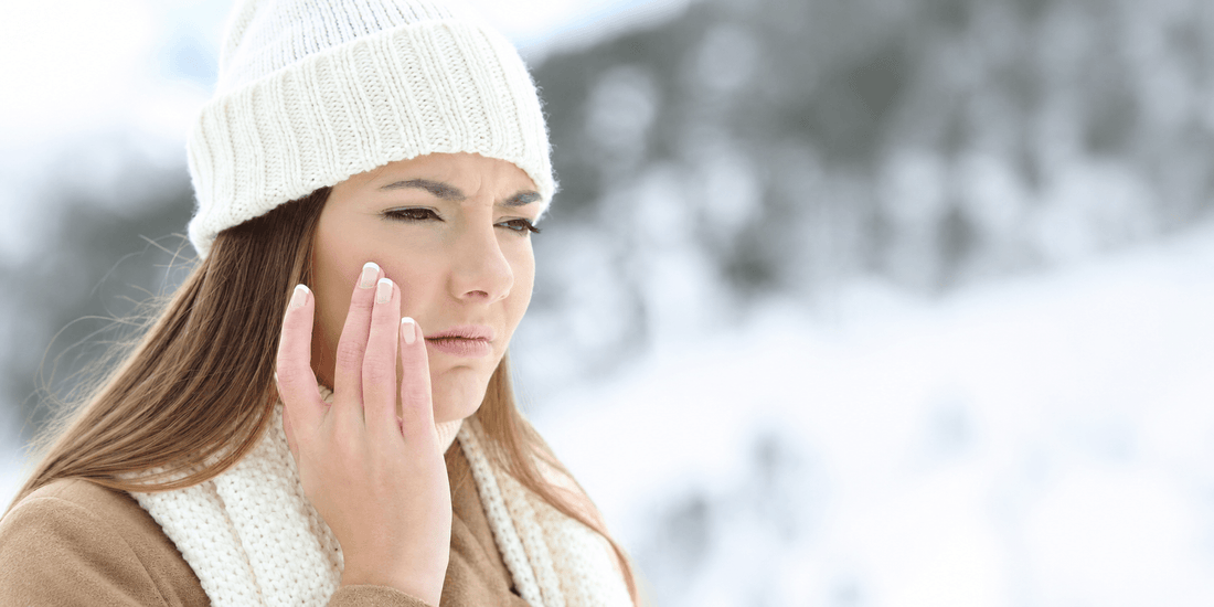 Woman dressed warmly in winter clothing outdoors in a snowy setting, representing winter care and seasonal wellness.