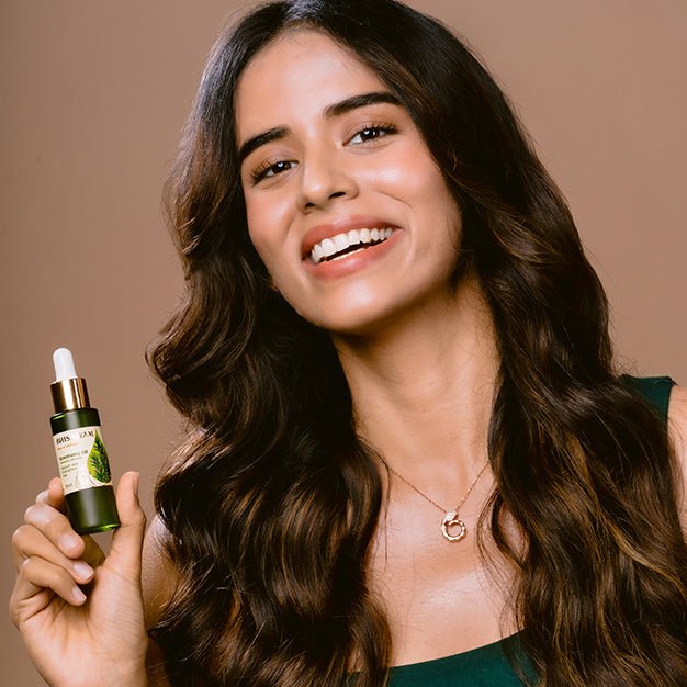 Using Bhisajyam Rosemary Essential Oil for scalp massage to reduce hair fall and promote hair growth